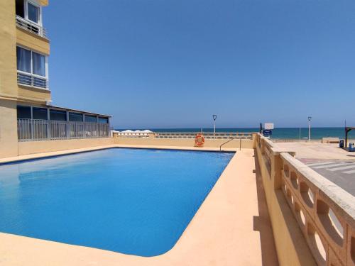 a swimming pool with the ocean in the background at Apartamento Gandia Bellreguard 3000 in Bellreguart