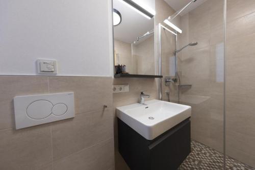 a bathroom with a sink and a shower at Nationalpark Chalet Hoher Sonnblick in Neukirchen am Großvenediger