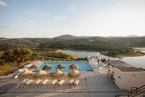 a view of a resort with a pool and mountains at Hoteles Desconecta2 in Monesterio