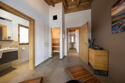 a bathroom with a sink and a mirror at Nationalpark Chalet Säulspitze in Neukirchen am Großvenediger