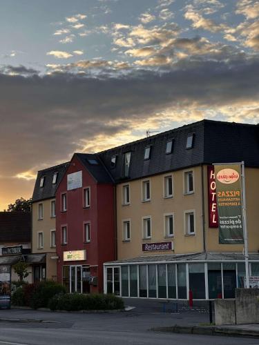 a group of buildings in a parking lot at Brit Hotel La Ferté sous Jouarre in La Ferté-sous-Jouarre