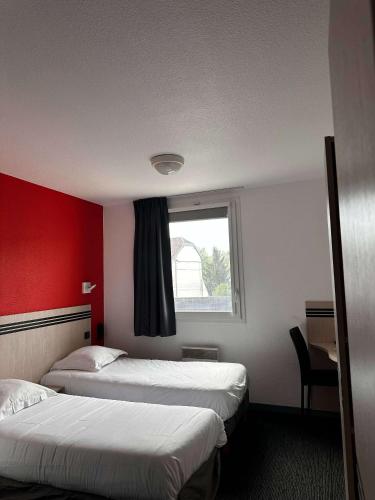 a hotel room with two beds and a window at Brit Hotel La Ferté sous Jouarre in La Ferté-sous-Jouarre