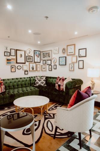 a living room with a green couch and a table at Chamberlain West Hollywood in Los Angeles