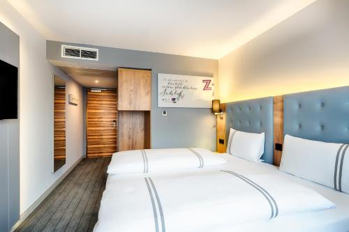 a hotel room with two beds and a window at Premier Inn Lindau in Lindau