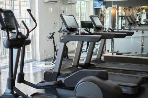 a gym with rows of tread machines in a room at Chamberlain West Hollywood in Los Angeles