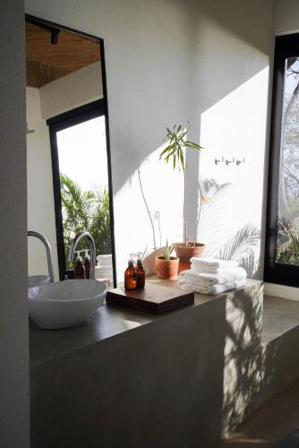 a bathroom with a sink and a mirror at Mint Santa Teresa - Adults only in Santa Teresa Beach
