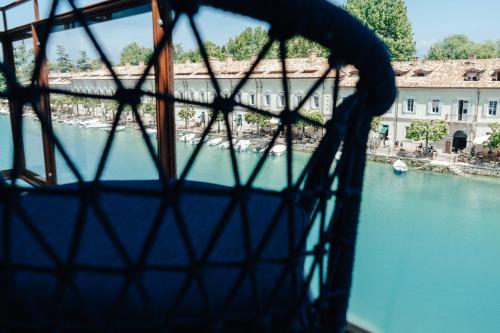 a view of a river with boats in the water at C House Rooms Lake in Peschiera del Garda