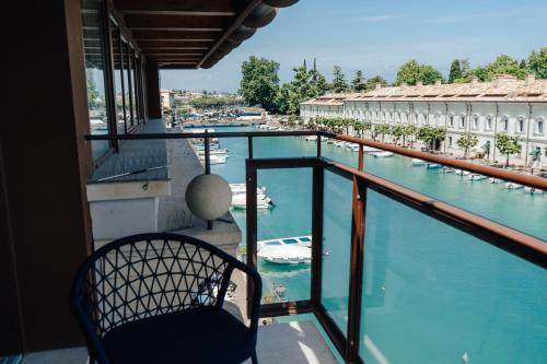 a balcony with a view of a marina at C House Rooms Lake in Peschiera del Garda