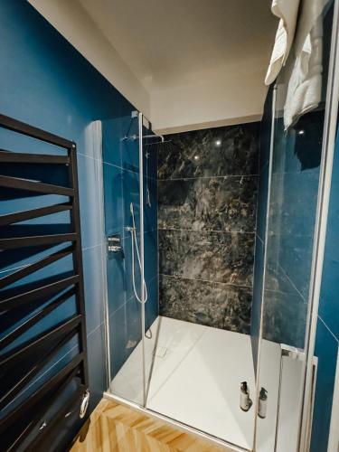 a shower with a glass enclosure in a bathroom at C House Rooms Lake in Peschiera del Garda