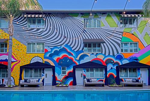a mural on the side of a building with a pool at Hotel Ziggy On Sunset in Los Angeles