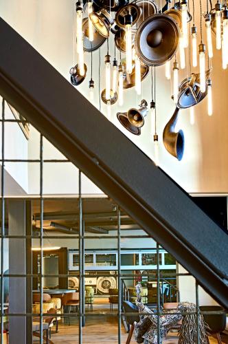 a chandelier in a restaurant with tables and chairs at Hotel Ziggy On Sunset in Los Angeles