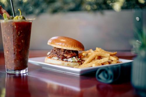 a sandwich and french fries on a plate with a drink at Hotel St. Michael, BW Premier Collection in Prescott