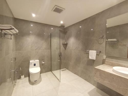 a bathroom with a shower and a toilet and a sink at Al Masem Serviced Apartments - Al Olaya - Exit 5 in Riyadh