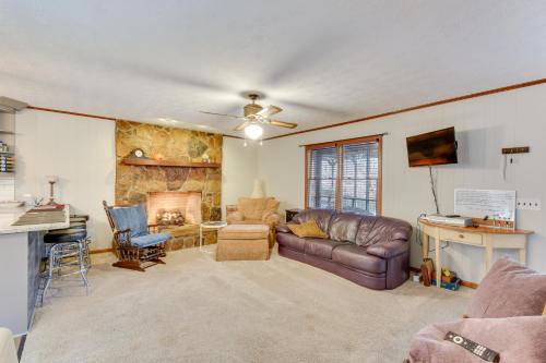 a living room with a couch and a fireplace at Cozy Hiawassee Cabin - 4 Mi to Lake Chatuge! in Hiawassee