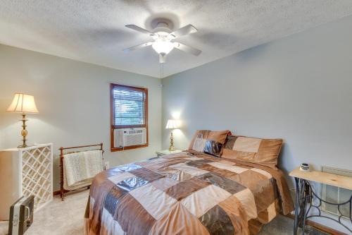 a bedroom with a bed and a ceiling fan at Cozy Hiawassee Cabin - 4 Mi to Lake Chatuge! in Hiawassee