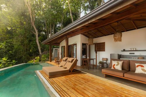 a villa with a swimming pool and a house at Diviya Villa - Madiha Hill in Madihe East