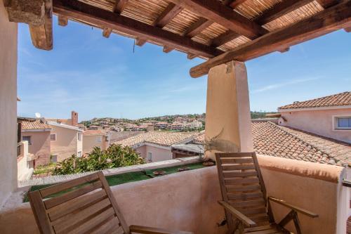 a view from the balcony of a house with two chairs at Porto Cervo Two-Levels Apt with Balconies and Parking in Porto Cervo