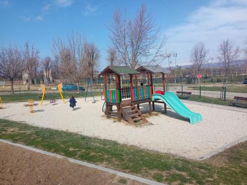 a playground with a slide in a park at OPERA LUX APARTMENTS - Green Hill kompleks Sokobanja & Free Parking - kod Akva Parka in Soko Banja