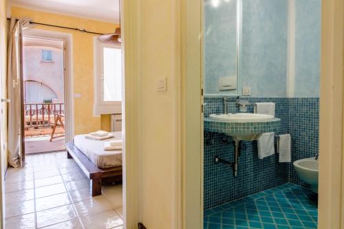 a bathroom with a sink and a mirror and a tub at Porto Cervo Two-Levels Apt with Balconies and Parking in Porto Cervo