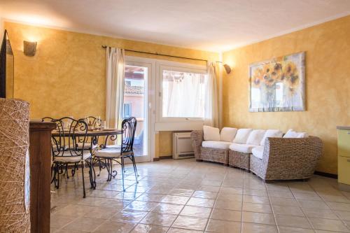 a living room with a table and a couch at Porto Cervo Two-Levels Apt with Balconies and Parking in Porto Cervo