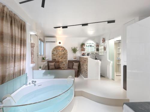 a bathroom with a tub and a living room at Island Vibes in Athens