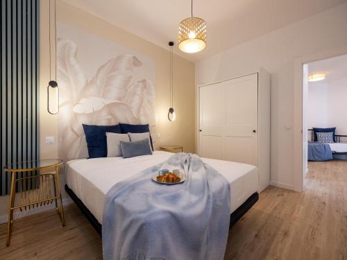 a bedroom with a bed with a plate of food on it at Torremolinos Centro Apartamento con parking y playa a 5 min, wifi alta velocidad in Torremolinos