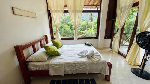 Postel nebo postele na pokoji v ubytování Hotel talú tayrona