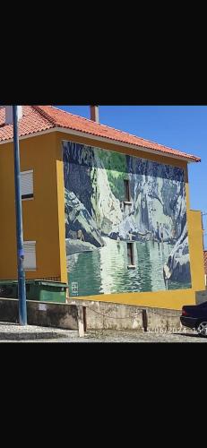 a building with a large mural on the side of it at Apartamento Fazunchar in Figueiró dos Vinhos