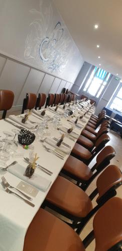 a conference room with a long table and chairs at Logis Grand Hôtel De L'Europe in Langres