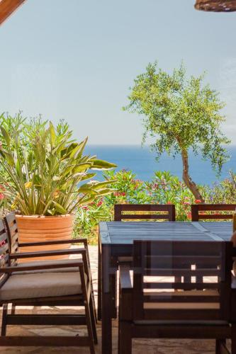 a table and chairs with a view of the ocean at Villas Maher One in Vasilítsion