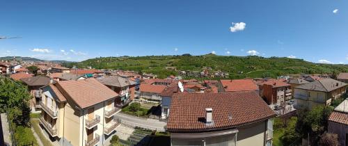an aerial view of a town with buildings and hills at Gfamily affittacamere in Alba