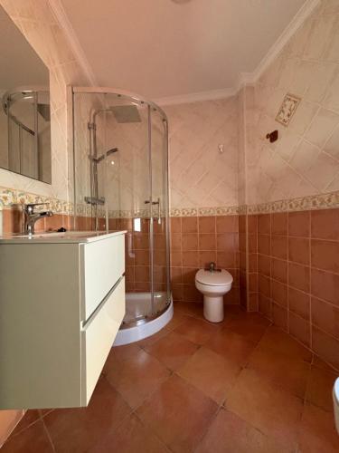 a bathroom with a shower and a toilet in it at Asís 20 in Medina Sidonia