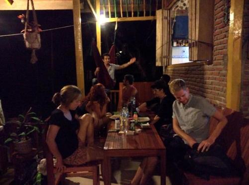 a group of people sitting at a table in a restaurant at Olala Bungalows and Restaurant in Sabong