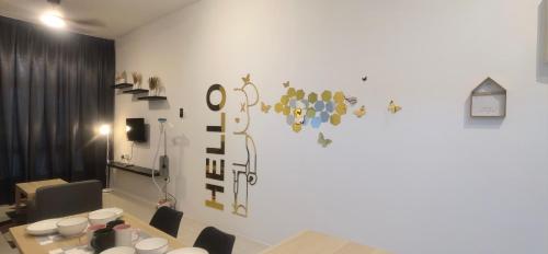 a room with a table with chairs and a wall at Anderson Suite by Hopestay Property Management in Ipoh