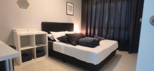 a bedroom with a bed with a laptop on it at Anderson Suite by Hopestay Property Management in Ipoh