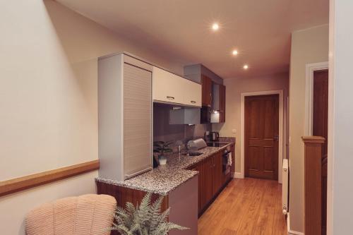a kitchen with a counter top in a room at Longlands Inn & Cottages in Carnforth
