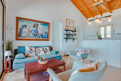 a living room with a couch and a table at Villas Maher One in Vasilítsion