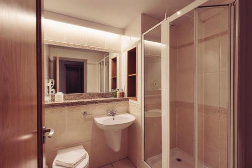 a bathroom with a toilet and a sink and a shower at Longlands Inn & Cottages in Carnforth