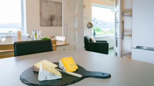 a plate of different types of cheese on a table at Eryri in Beaumaris