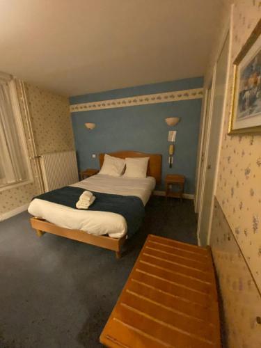 a bedroom with a bed in a room at Logis Grand Hôtel De L'Europe in Langres