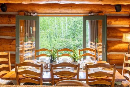 a dining room with a table and a large window at The Luxury Cabin at Comfort Circle in Ketchum