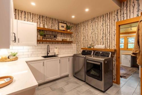 a kitchen with a stove and a dishwasher at The Luxury Cabin at Comfort Circle in Ketchum
