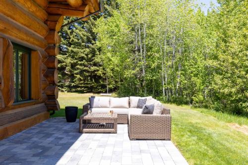 a patio with a couch and a table on a house at The Luxury Cabin at Comfort Circle in Ketchum