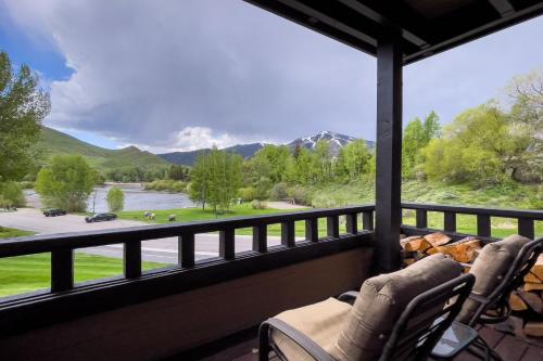 a screened in porch with a view of the mountains at Spacious Wildflower Condo with Baldy Views in Sun Valley