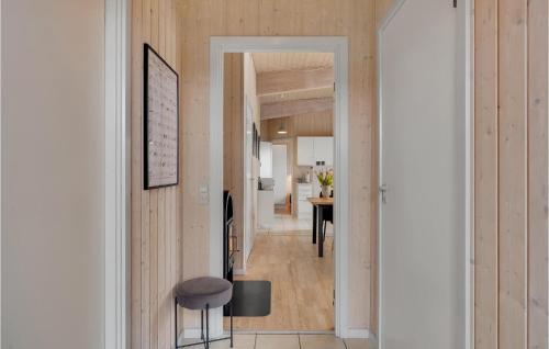 a hallway leading into a home with wood paneling at Stunning Home In Faaborg With Kitchen in Bogentved