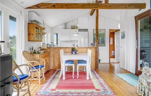 a kitchen and dining room with a table and chairs at Holiday Home Nordvangsvej With Fireplace And Shower in Allingåbro