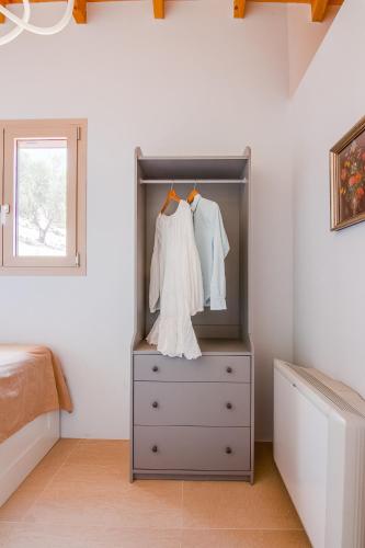 a bedroom with a dresser and a white dresser at Villas Maher One in Vasilítsion