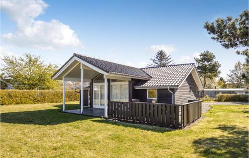a small house with a deck in a yard at 3 Bedroom Amazing Home In Nakskov in Nakskov