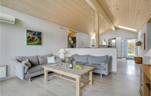 a living room with two couches and a table at 3 Bedroom Amazing Home In Nakskov in Nakskov