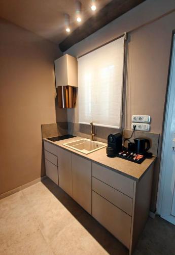 a kitchen with a sink and a counter top at Locanda in Monemvasia